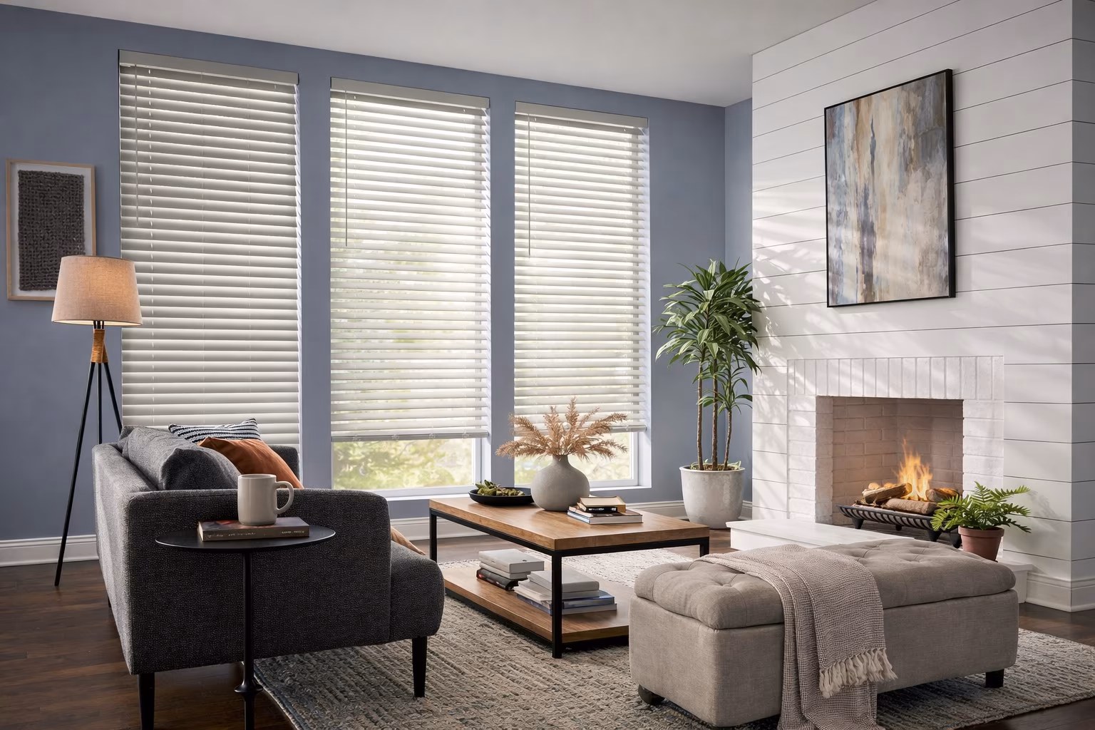 Hunter Douglas EverWood Alternative Wood Blinds on three windows in a modern living room with gray-blue walls shiplap fireplace and contemporary furnishings, installed by La Grange Window Coverings
