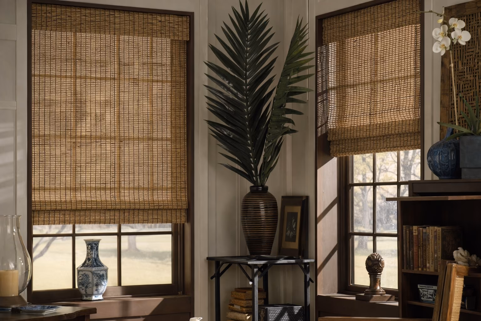 Hunter Douglas Provenance Woven Wood Shades in natural bamboo weave on windows of a traditional home study with dark wood furniture, installed by La Grange Window Coverings