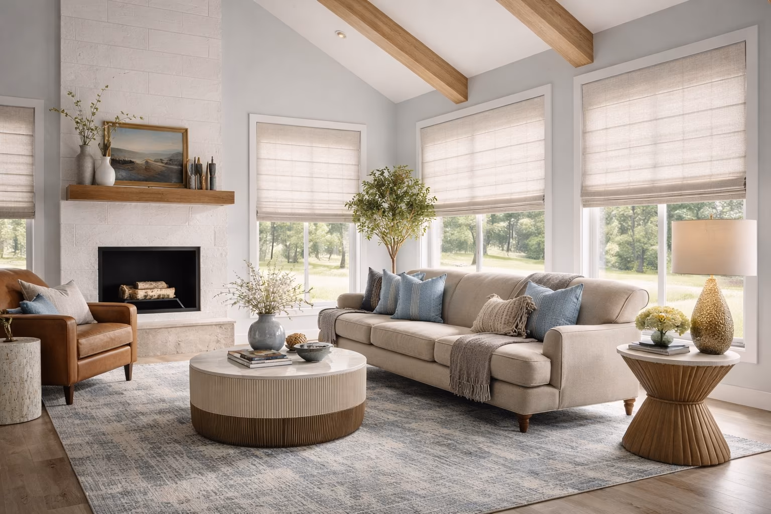 Hunter Douglas Roman Shades on multiple windows in a modern farmhouse living room with vaulted beam ceiling white brick fireplace and blue pillows, installed by La Grange Window Coverings